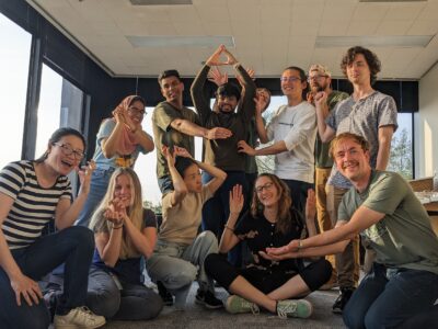Graduate students making playful hand gestures